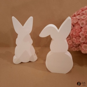 Due coniglietti in gesso bianco da appoggio.