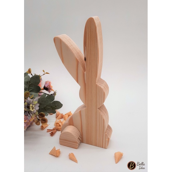 Coniglio in legno seduto con lunghe orecchie visto dietro