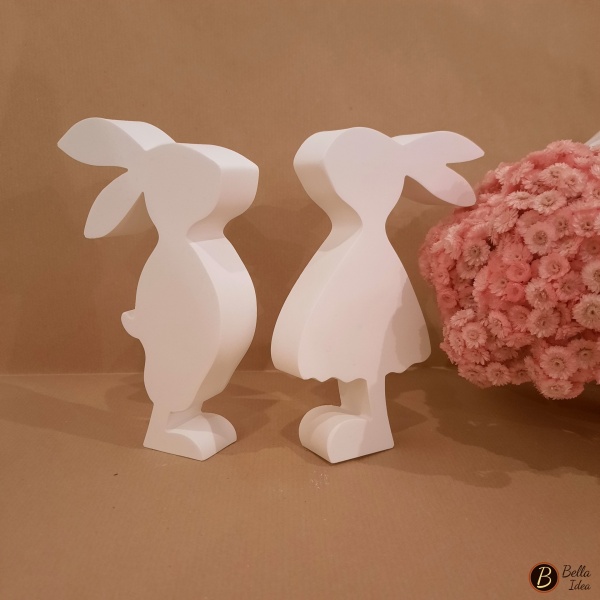 Coppia di conigli da appoggio in gesso bianco visti di lato.